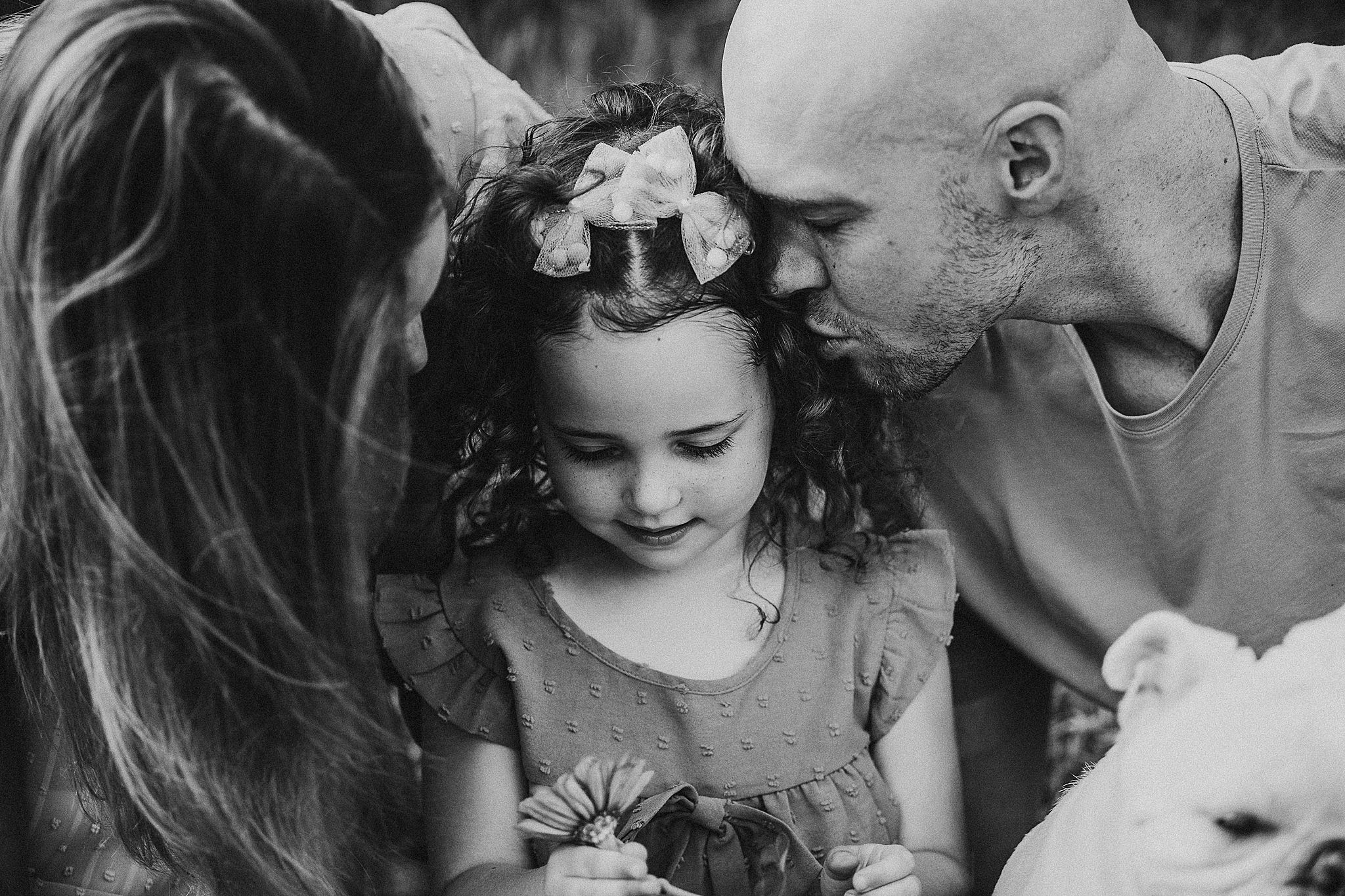 A collection of black and white candid wedding photos showing emotional moments between loved ones and couples.
