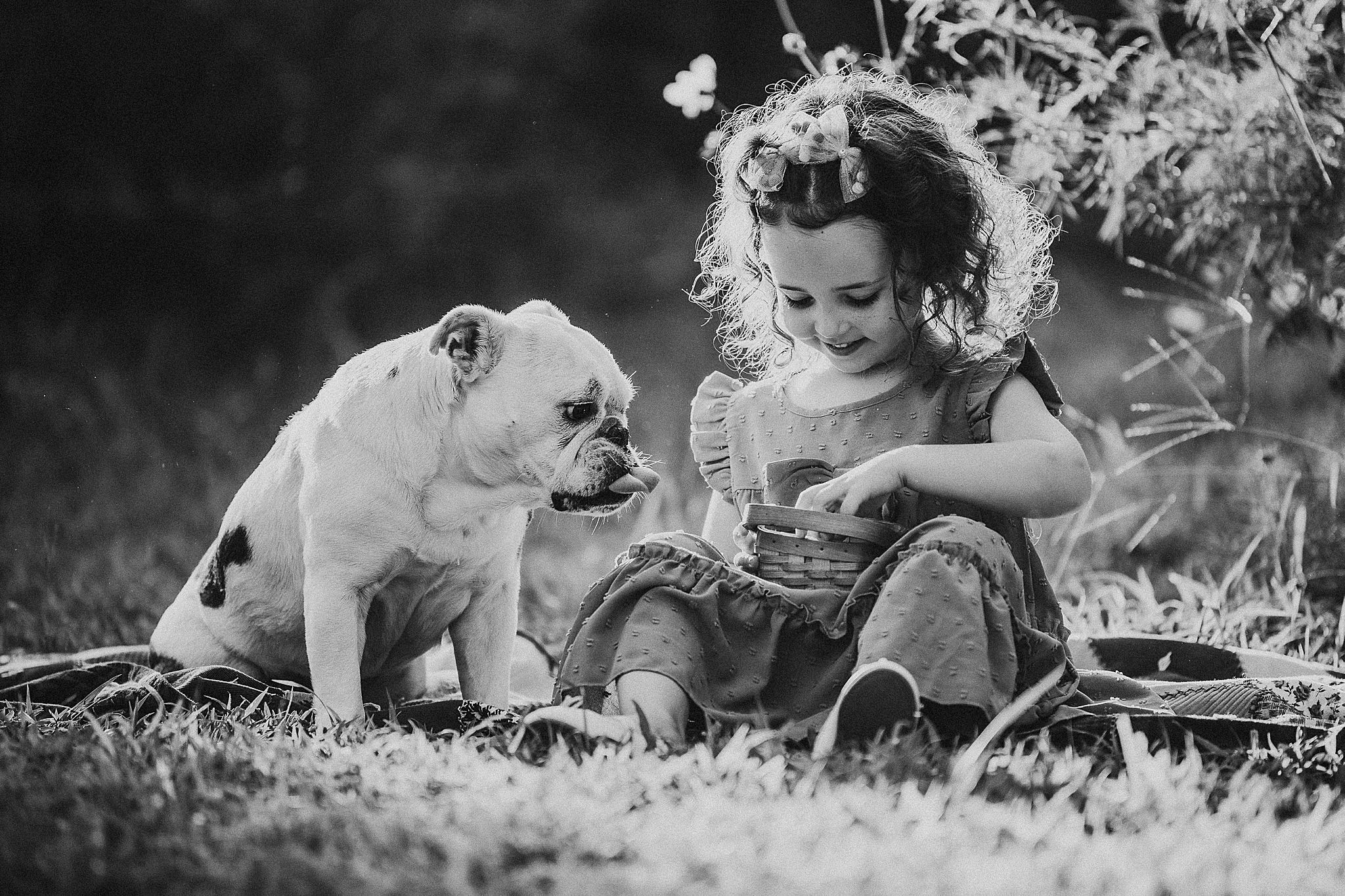 A series of black and white images showing people lying in grass with sunlit bokeh effects creating dreamy scenes.