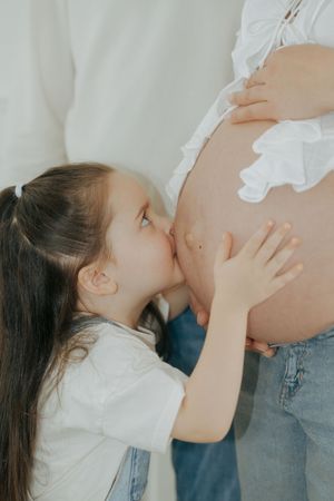 A loving couple shares tender moments while highlighting a pregnancy in a series of intimate photographs.