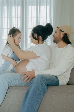 Intimate couple session on a gray couch showing tender moments in sequence from left to right.