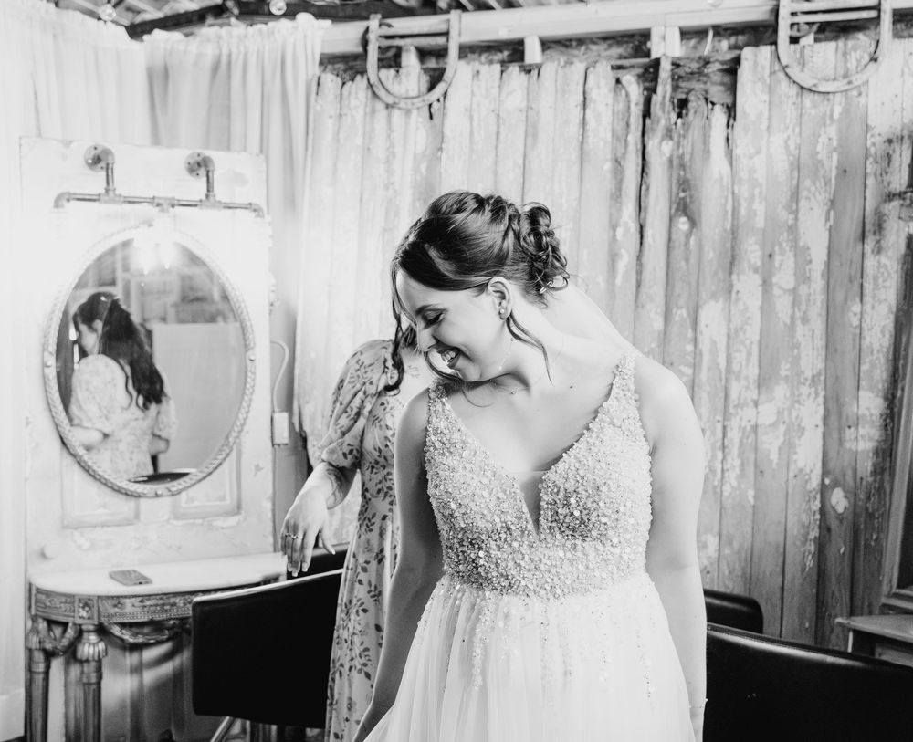 A vintage black and white wedding photograph showing elegant details from a romantic indoor celebration.