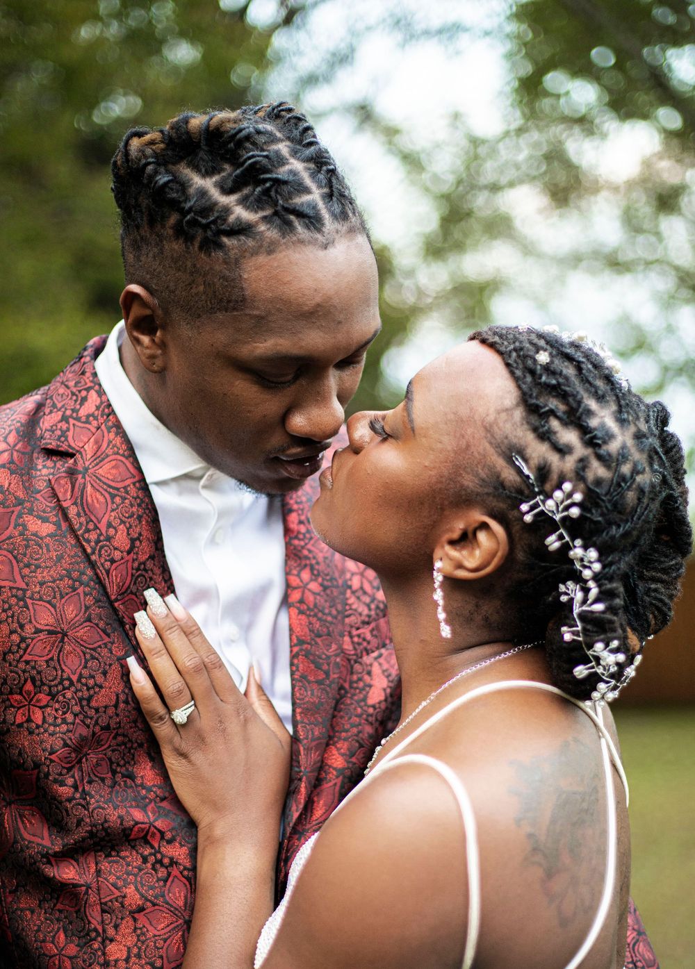 A romantic wedding moment shared between a couple outdoors.