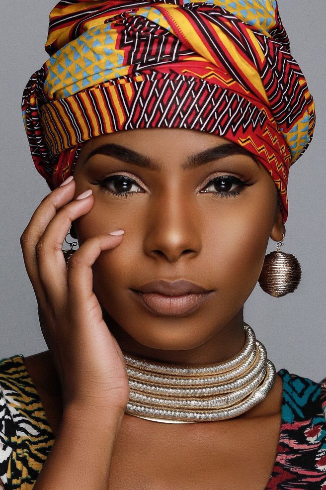 Beautiful African-inspired portrait featuring vibrant headwrap, layered choker necklace and metallic ball earring.