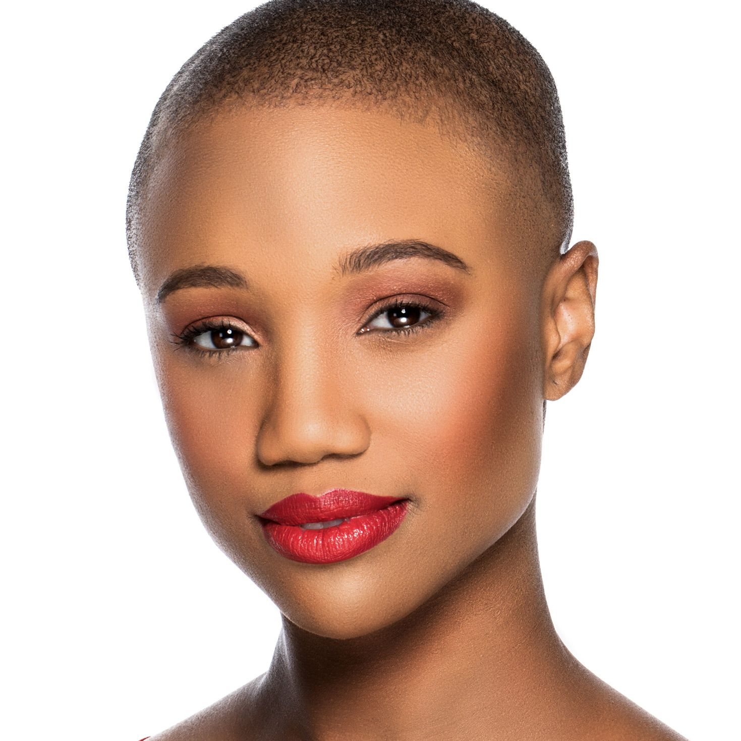 Beauty portrait showing natural makeup and glowing skin in a clean studio setting against white backdrop.