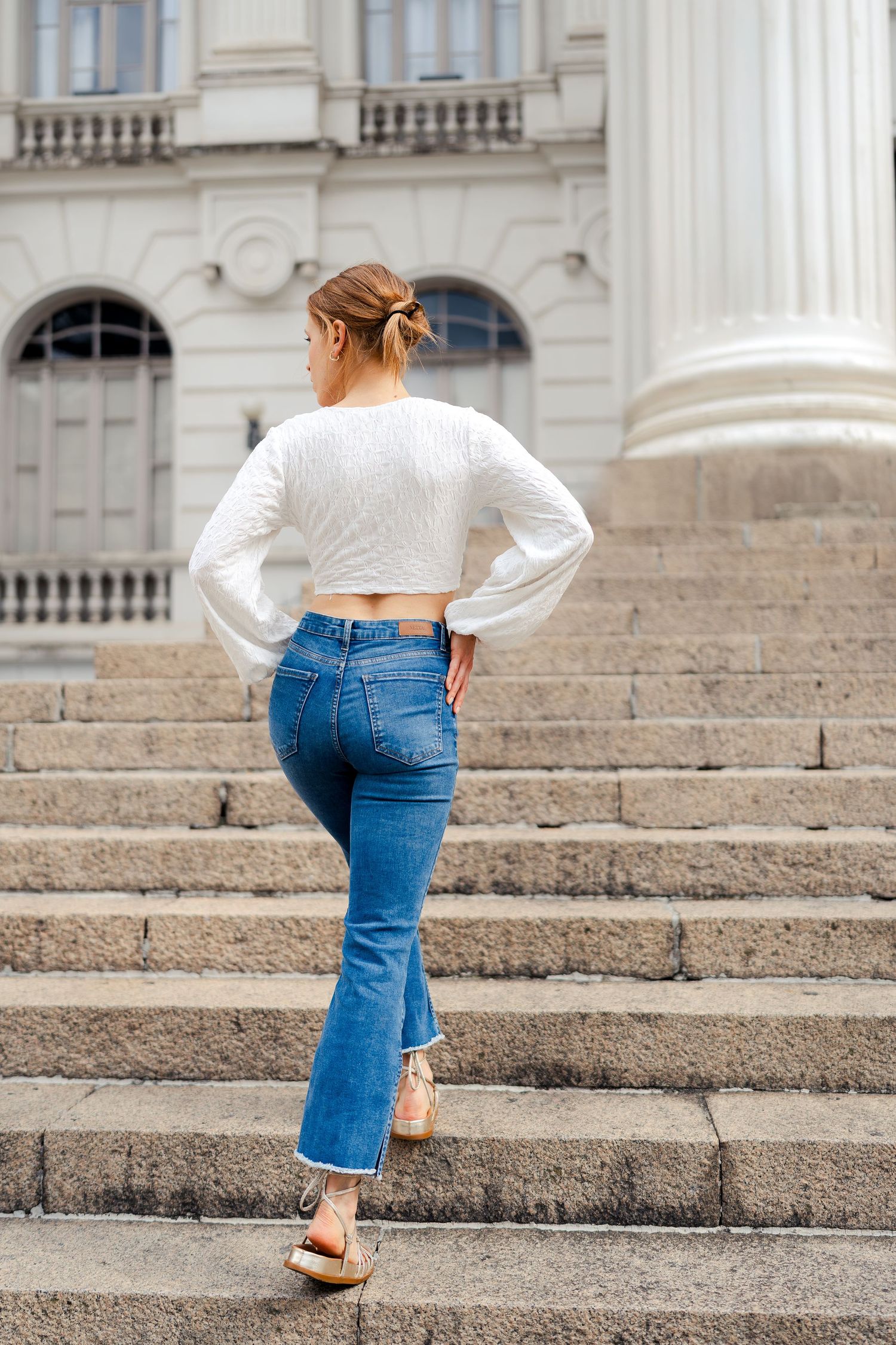 Multiple angles of casual denim style photographed on historic stone steps with white columns.