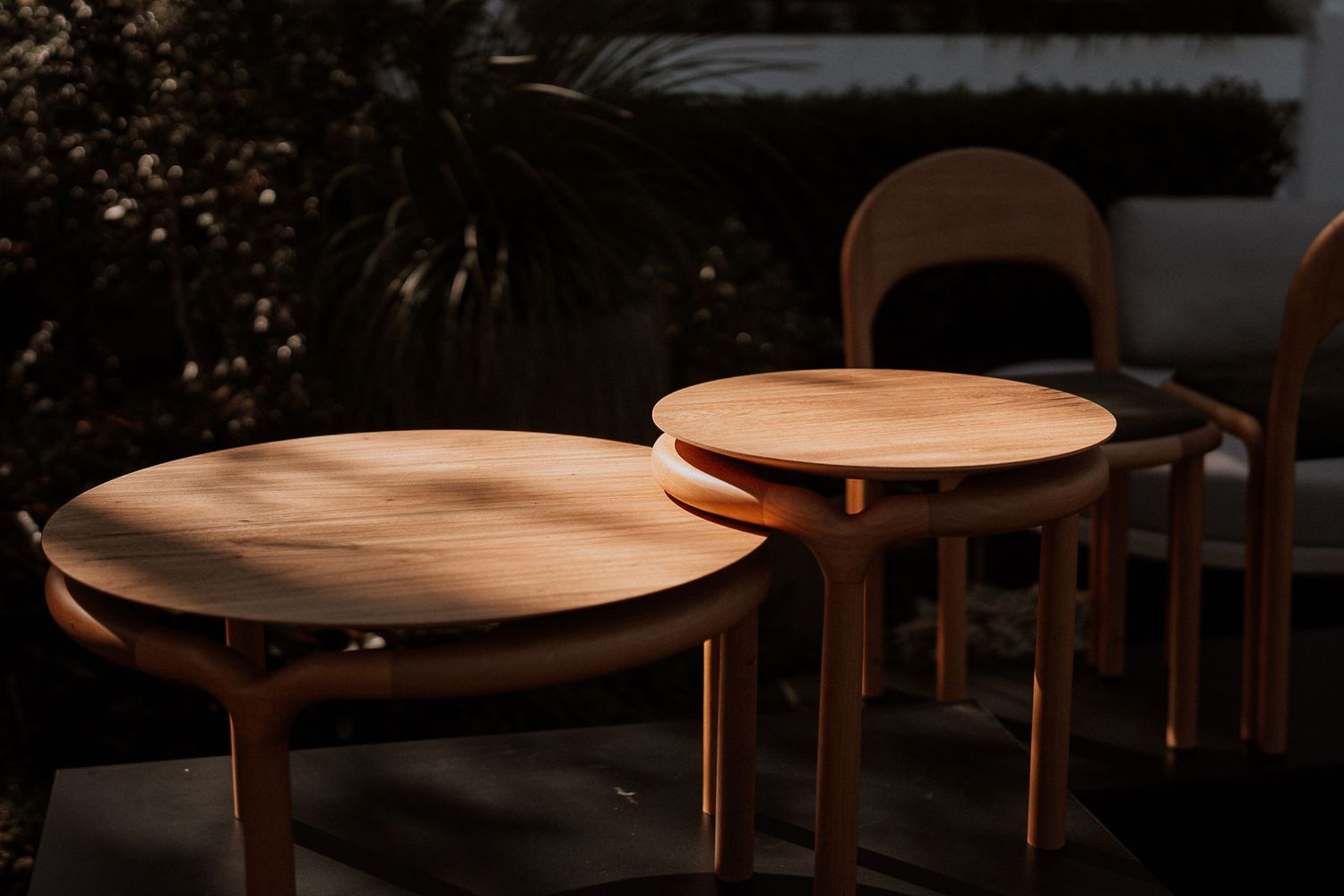 Wooden dining table with round top and tapered legs showcases elegant mid-century modern design in natural finish.