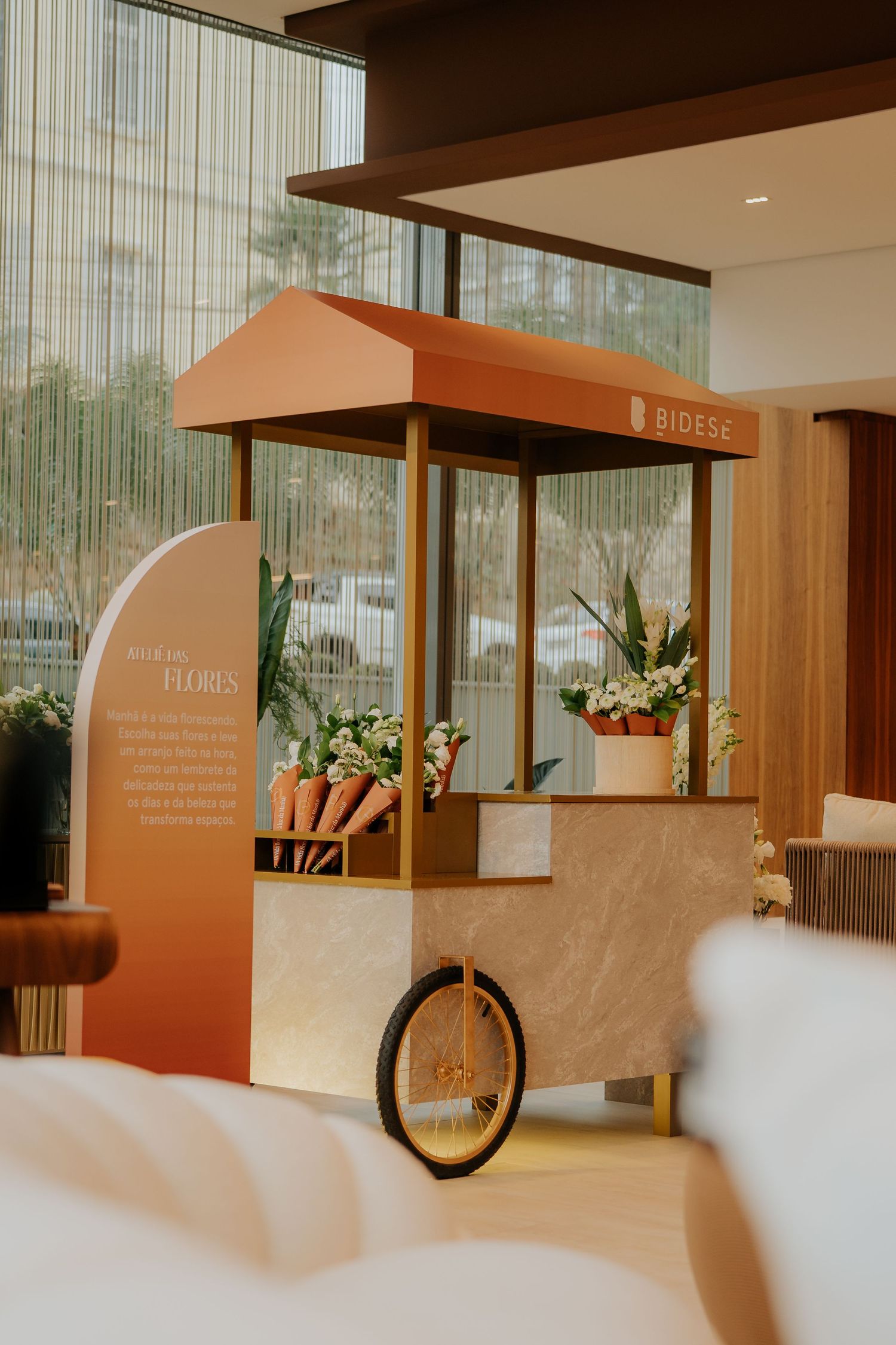 Minimalist gallery interior with orange display units and decorative bicycle elements against white walls.