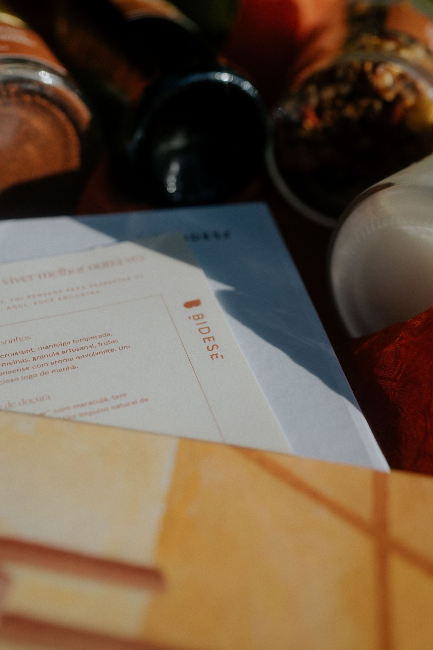 Close-up of documents and menu papers with blurred jars in background.