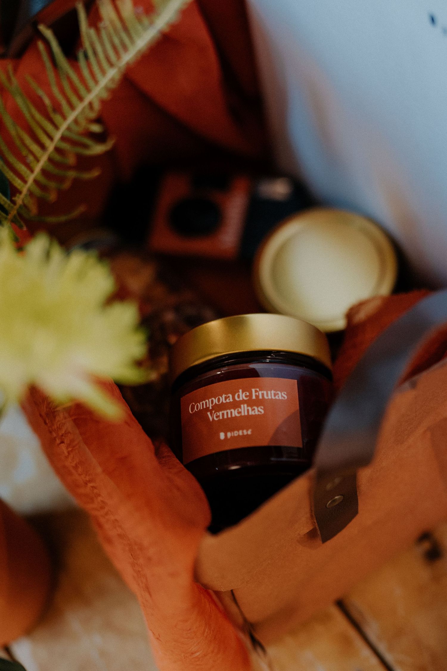Close-up of luxury skincare cream jar in warm lighting.