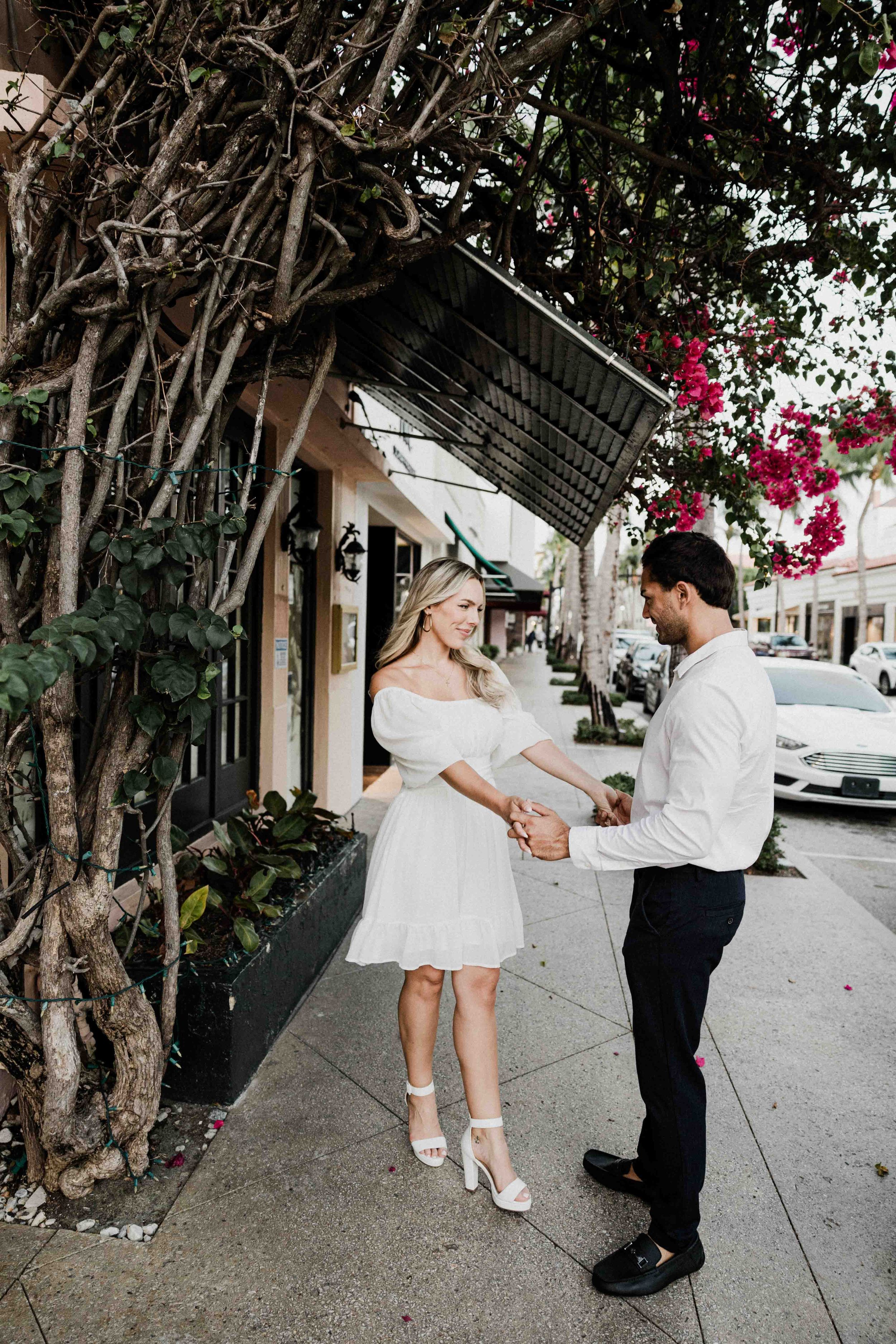 A romantic dance scene unfolds on a sidewalk framed by trees and buildings in a sequence of four connected photos.