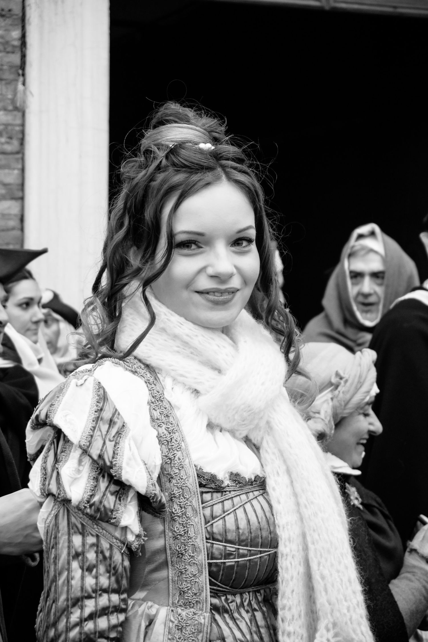 A split image shows someone wearing a white fur wrap and dark sequined outfit posing in different expressions.