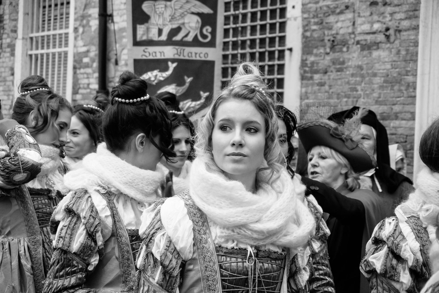 A montage of old black and white photographs showing crowds of immigrants arriving at Ellis Island in the early 1900s.