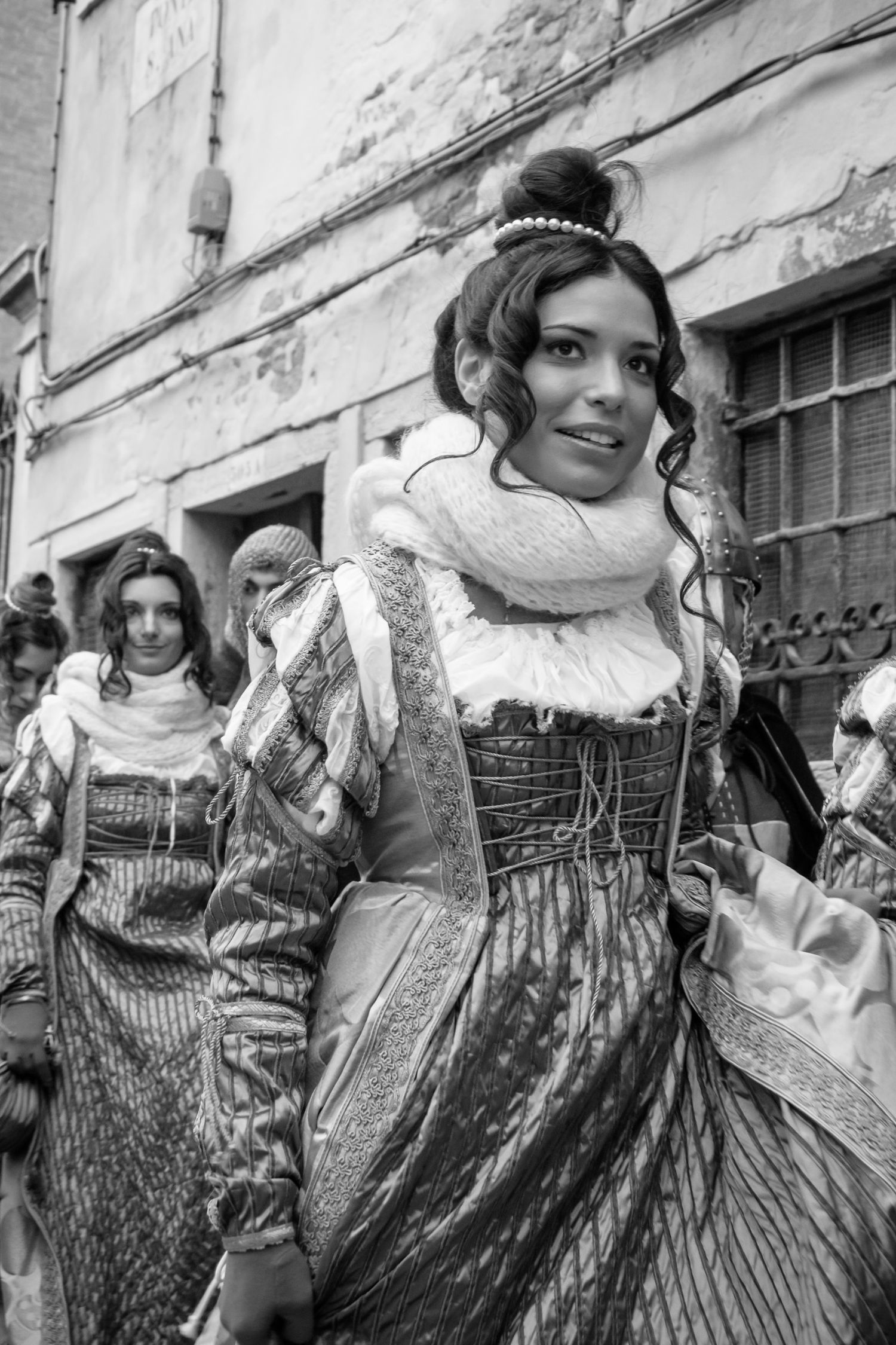 Black and white photo collage showing multiple artistic portrait shots with patterned dresses and retro styling.