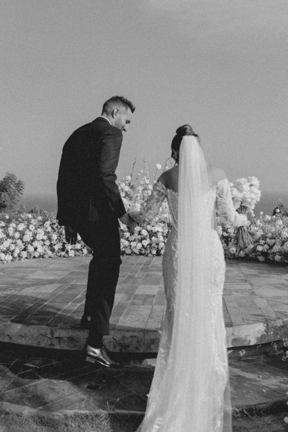 A black and white photo sequence shows a bride and groom sharing their first dance at an outdoor wedding reception.