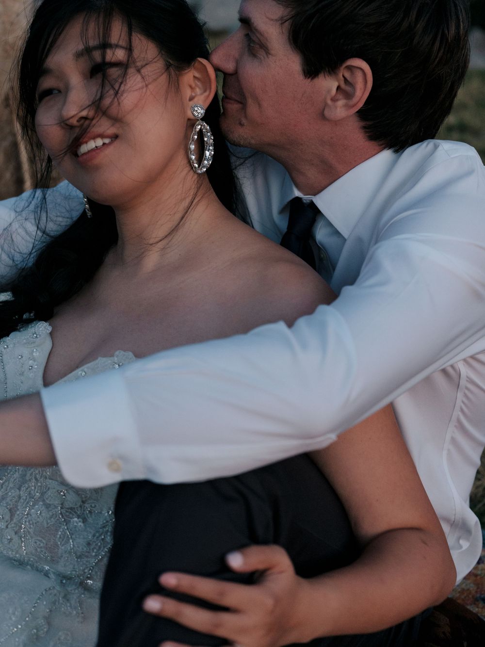 A couple shares an intimate and playful dance moment in a joyful sequence of black and white photographs.