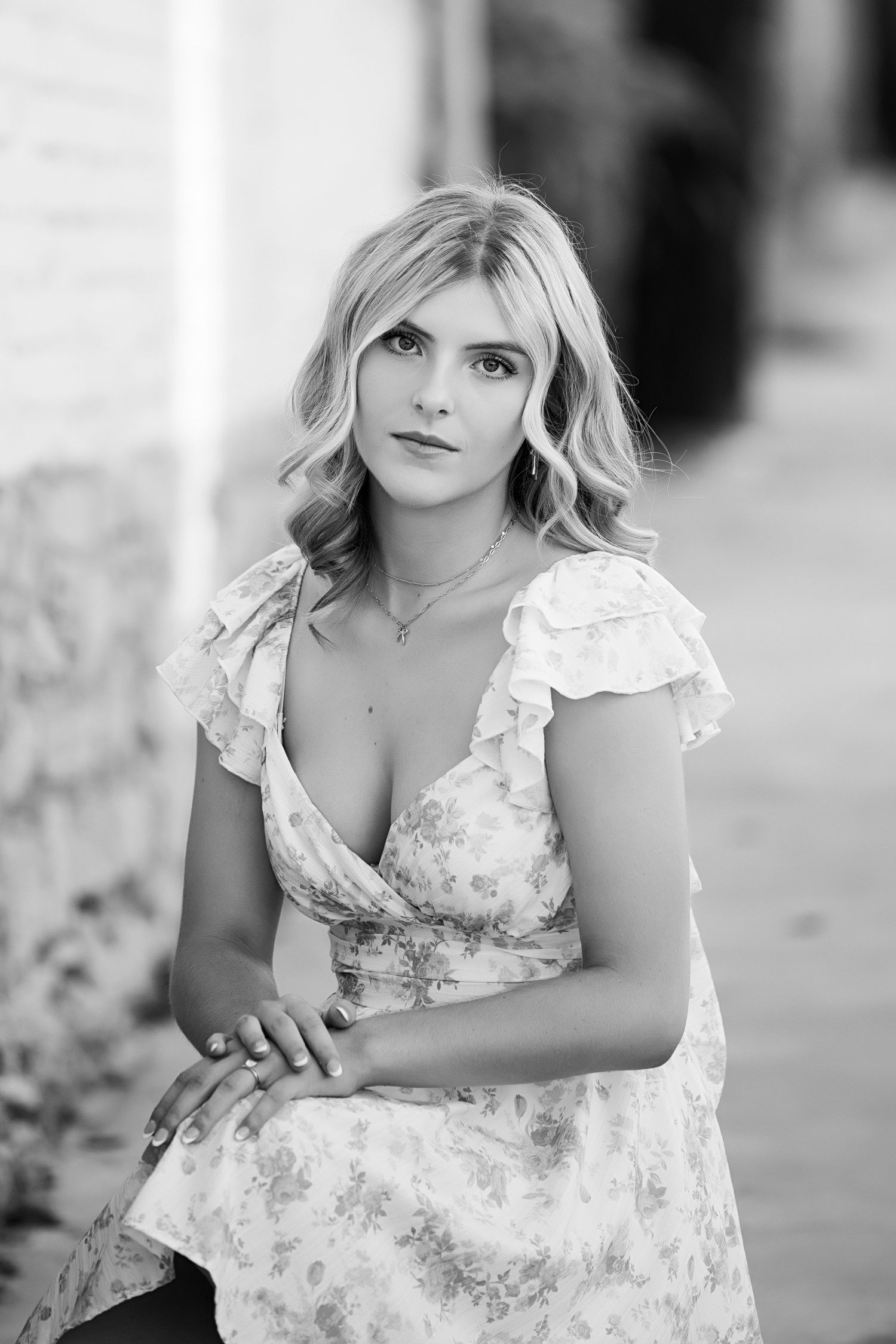 A black and white portrait series shows a young girl in a floral dress posing outdoors.
