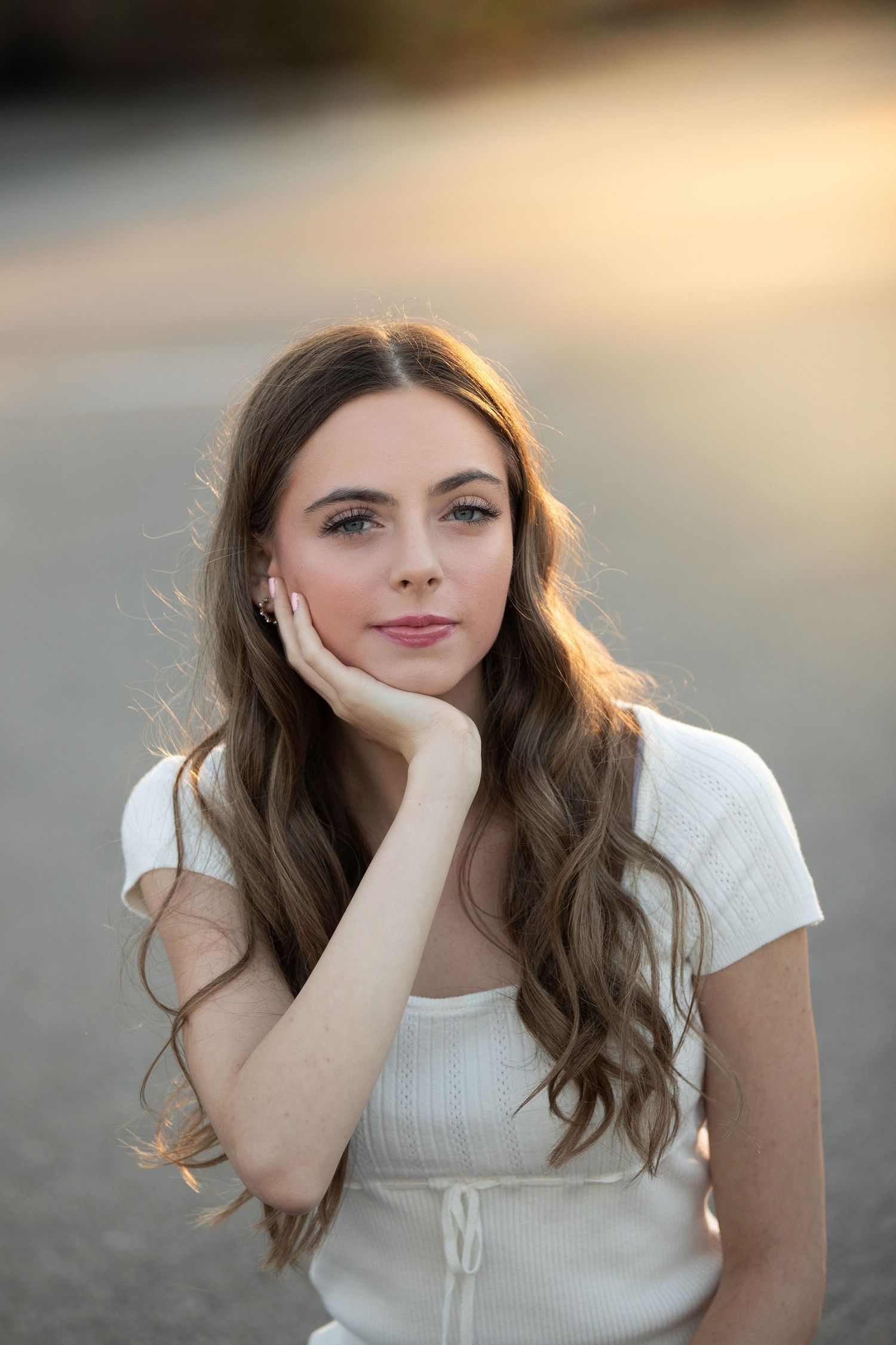 A portrait series showing a person in a white top with long brown hair against a soft blurred background in warm lighting.