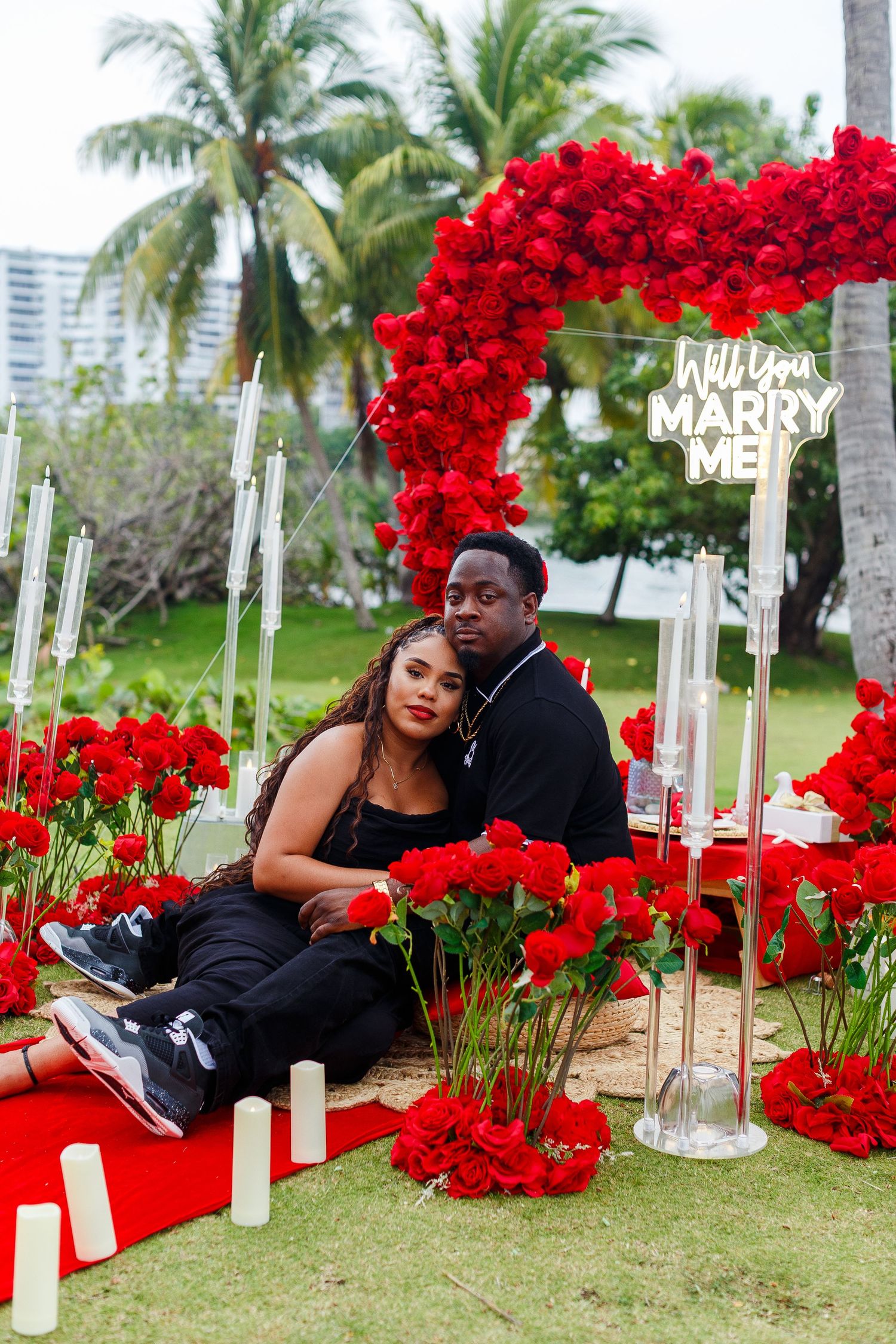 Couples portrait with red roses and heart arch in San Juan, Puerto Rico.