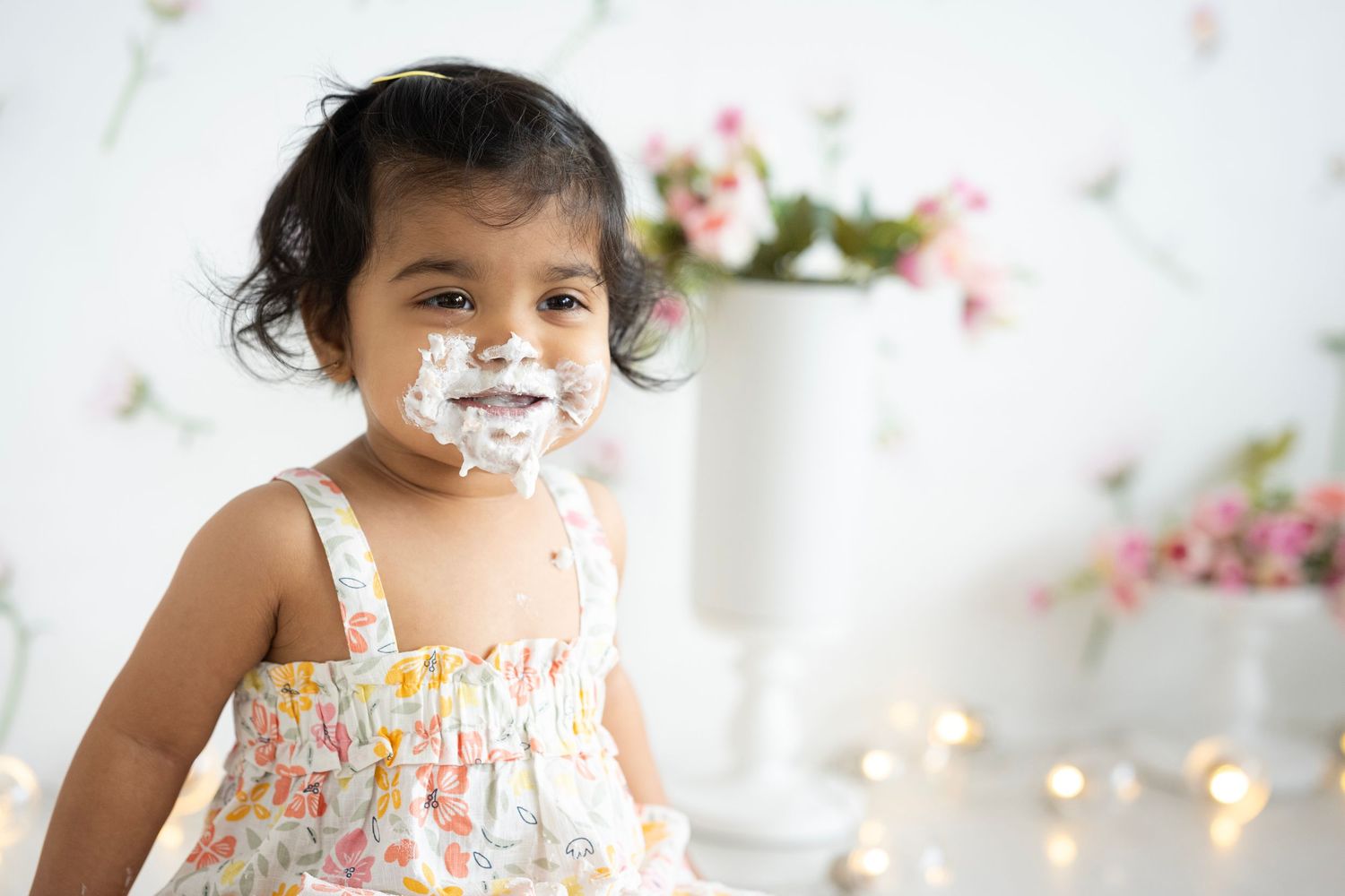 Sweet floral portrait session featuring a colorful dress and spring blossoms.