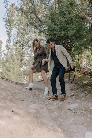 Candid outdoor photography session on a rocky forest trail.