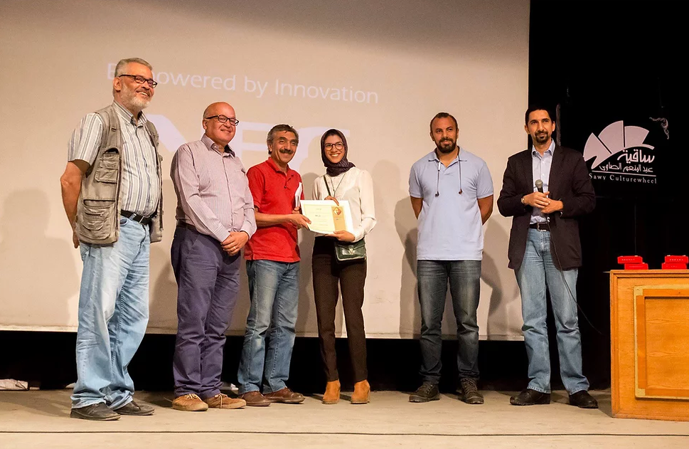 A group of people standing together on a stage during an awards or recognition ceremony.