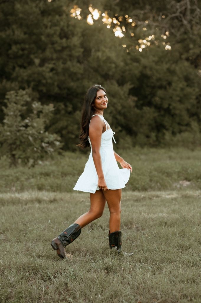 A sequence of playful poses in a white dress and cowboy boots against a rustic outdoor setting at sunset.
