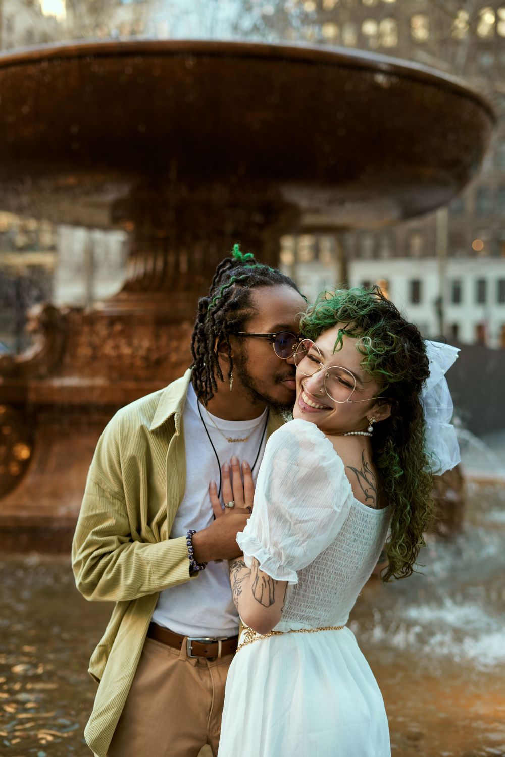 A romantic couple embraces and shares tender moments while posing together outdoors on an autumn day. Engagement shoot Manhattan