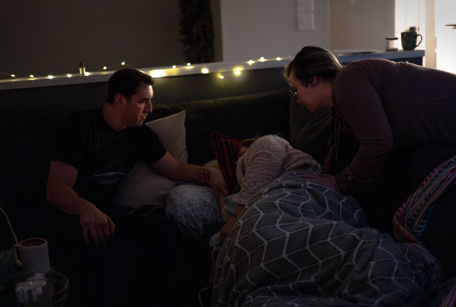 A dimly lit room with a glowing blue light creating a moody atmosphere.