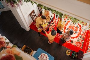 Overhead view of a festive Christmas market display with red decorations and twinkling lights.