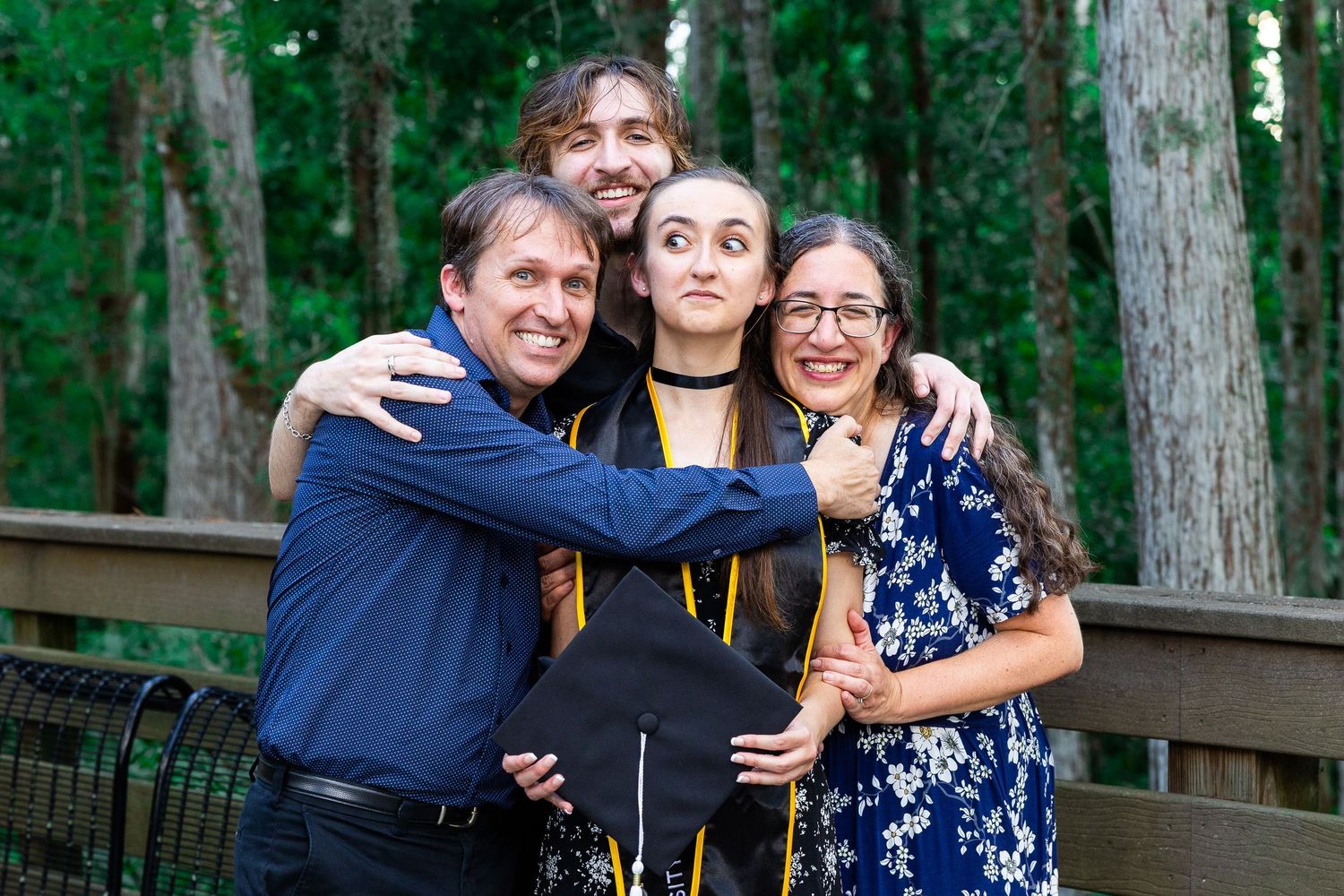 Candid celebration moments captured in a wooded outdoor setting.