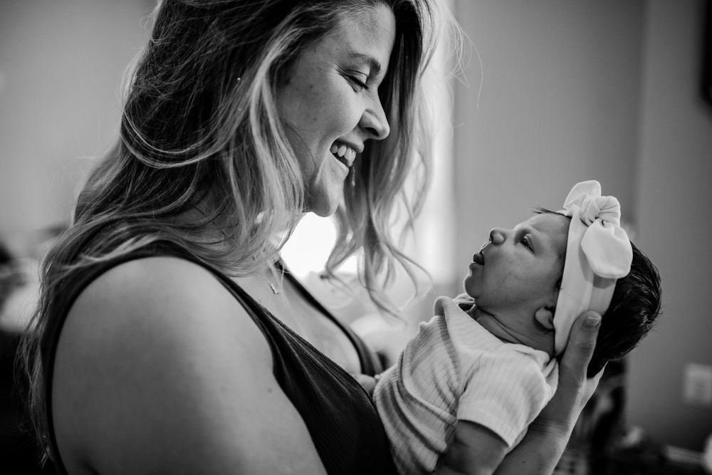A black and white photo series showing tender moments between a couple in an intimate setting.