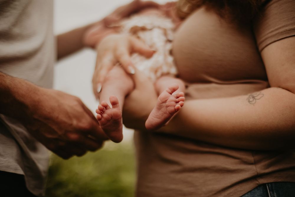 Close-up view of gentle hands tenderly touching in a warm, intimate moment.