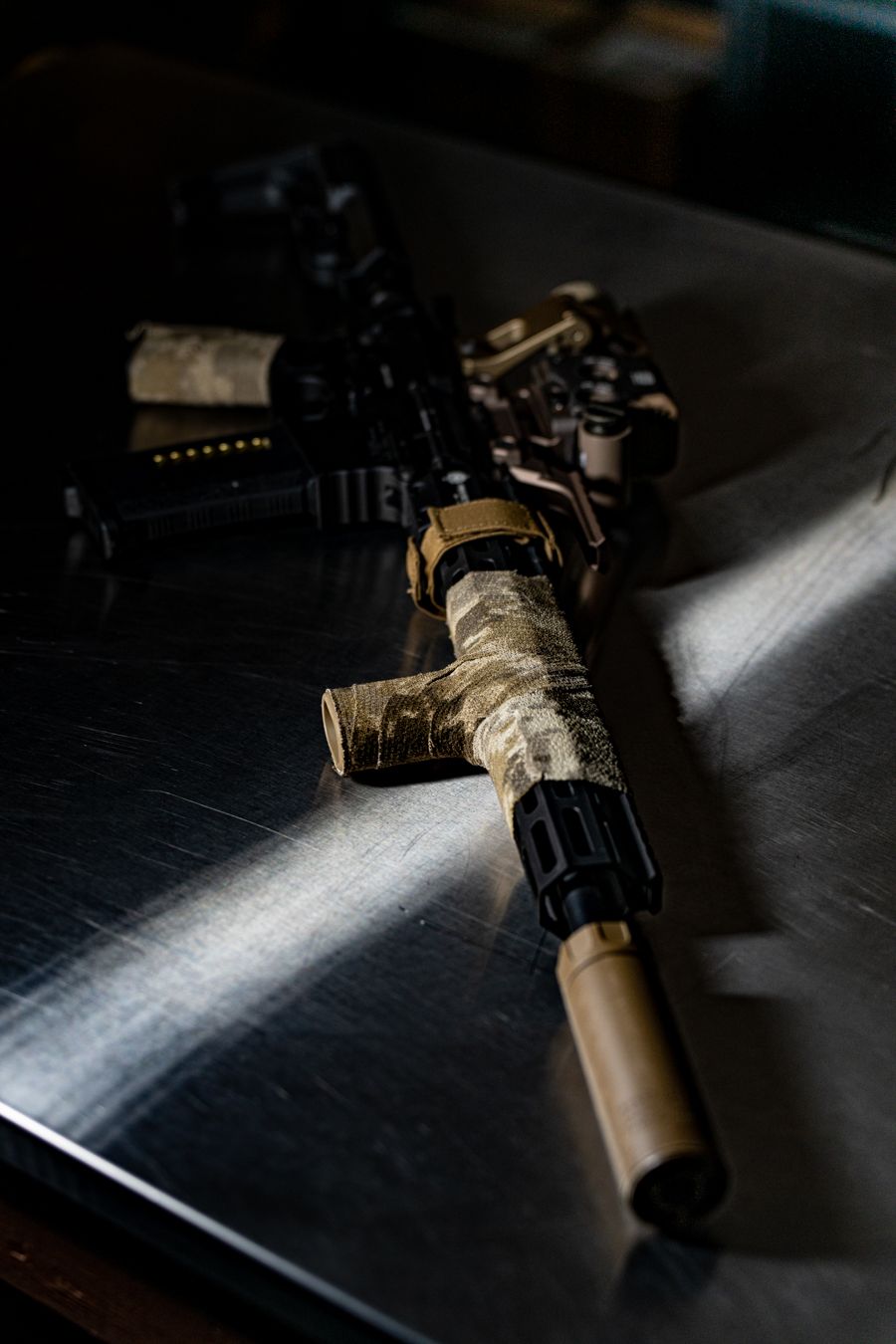 Tactical flashlight mounted on a black rifle showing different angles in dramatic lighting.