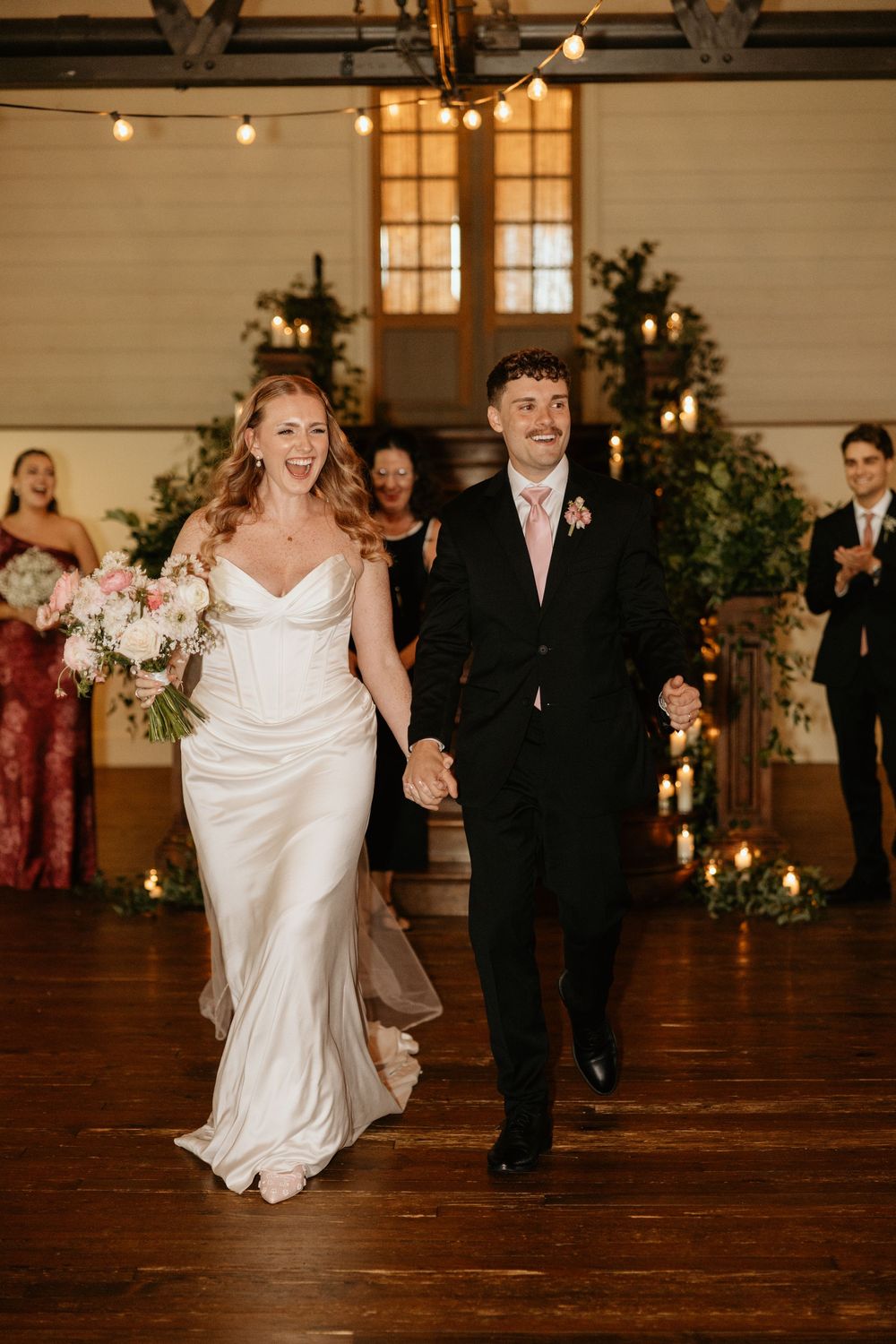 A bride and groom exiting their indoor wedding ceremony at Summerour Studio in Atlanta, Georgia