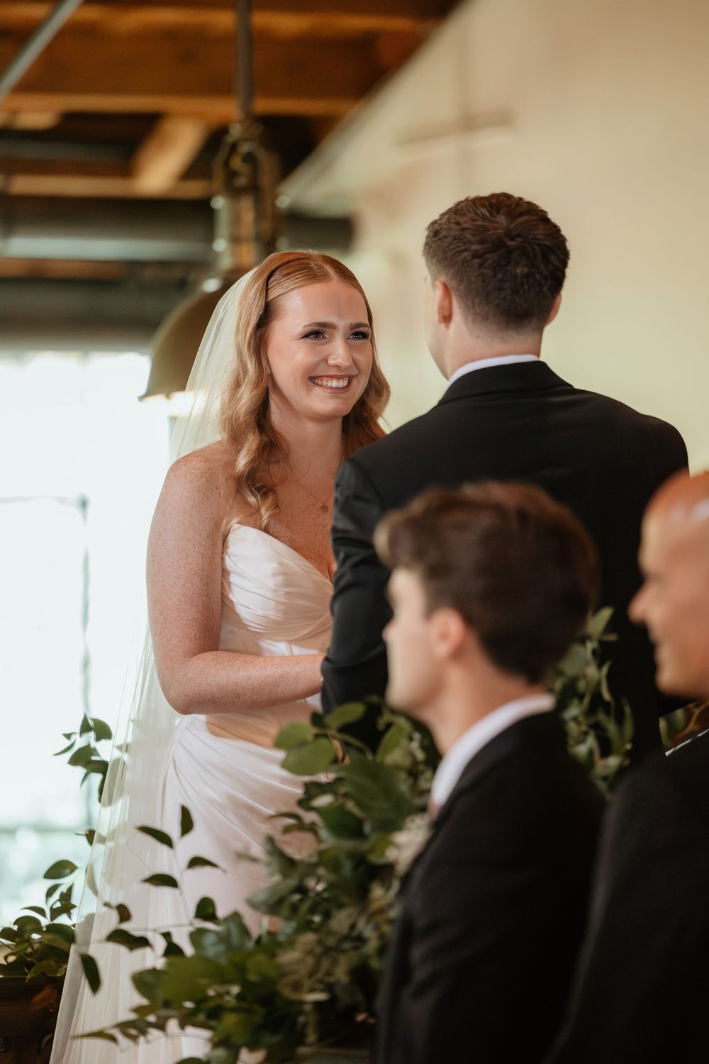 Bride and groom exchange vows during wedding ceremony at Summerour Studio in Atlanta, Georgia