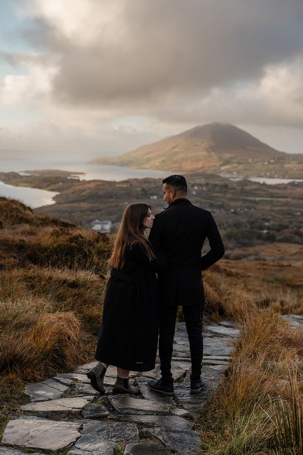 Hiking couple session on Diamond Hill with dramatic Connemara landscape