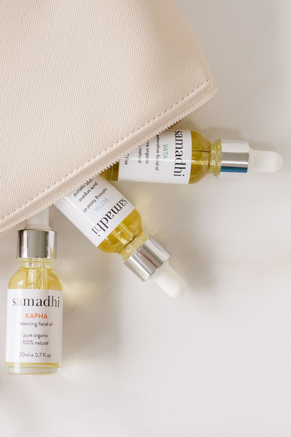 Brand photography of luxury skincare products styled inside a cosmetic bag
