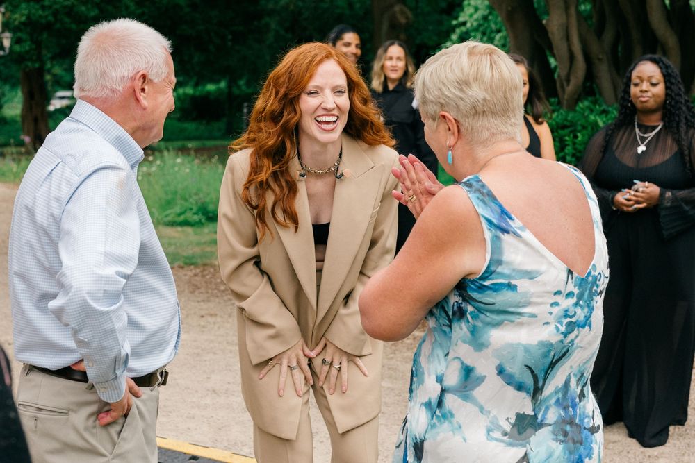 Corporate event photography of professionals networking at an outdoor business reception