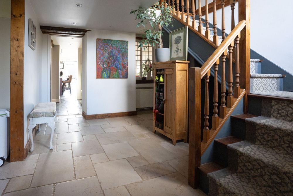 Property and interiors photography of a traditional hallway with wooden staircase