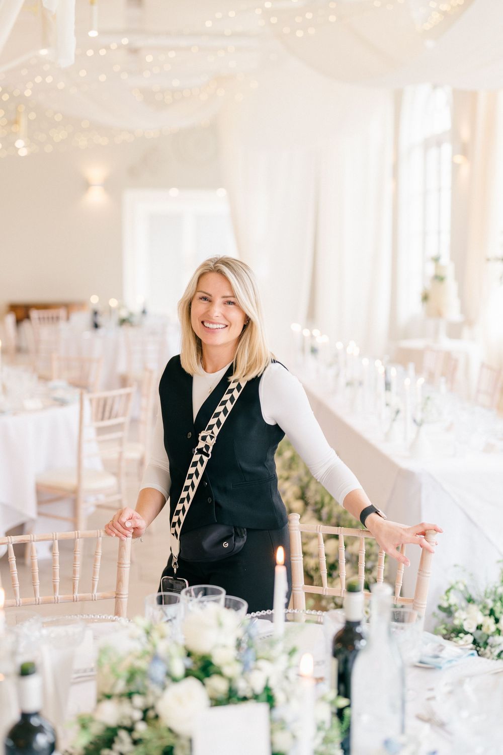 Brand photography of an event stylist preparing a luxury wedding reception space