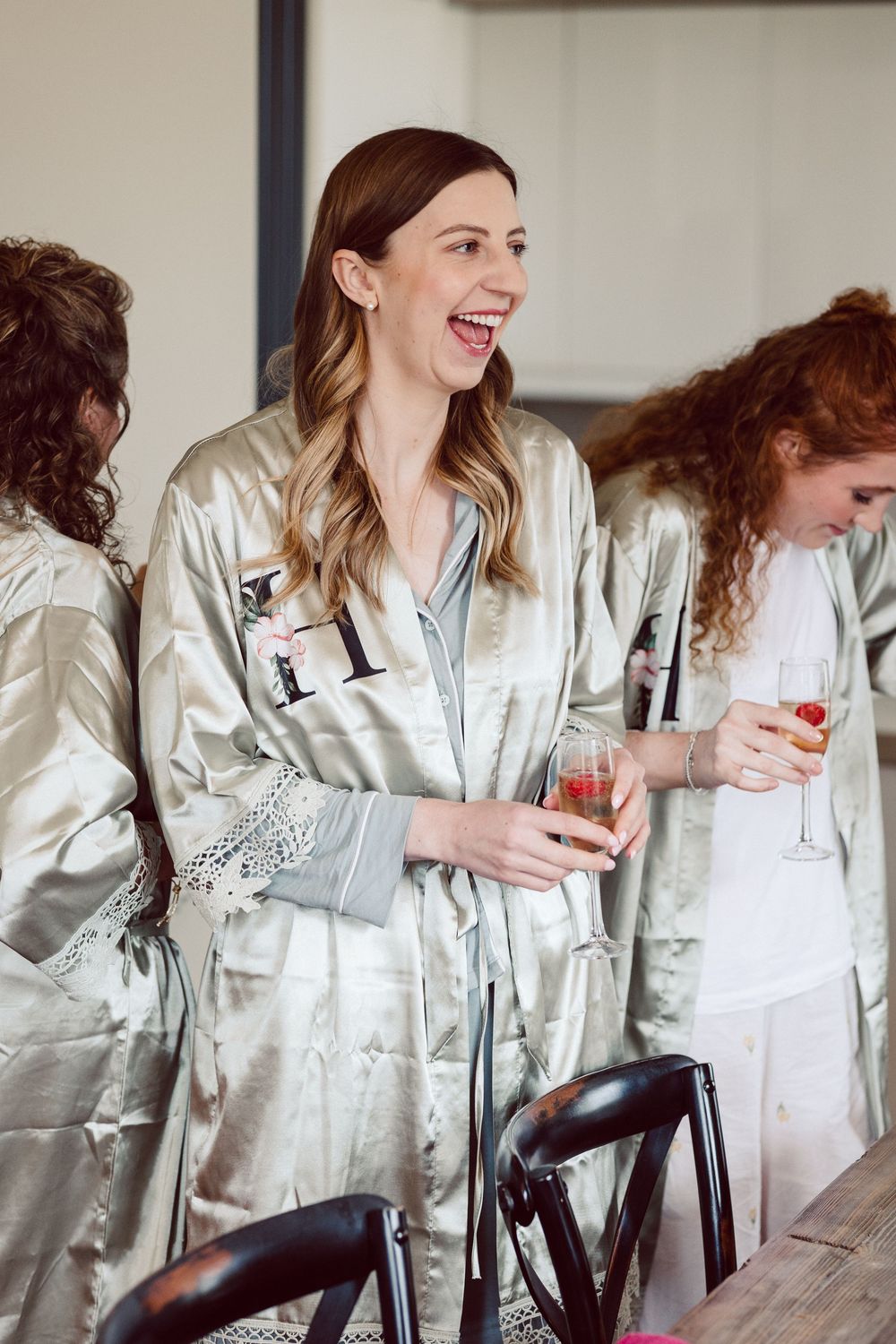 A sequence of photos showing someone in a white satin robe laughing while holding a drink at a gathering.
