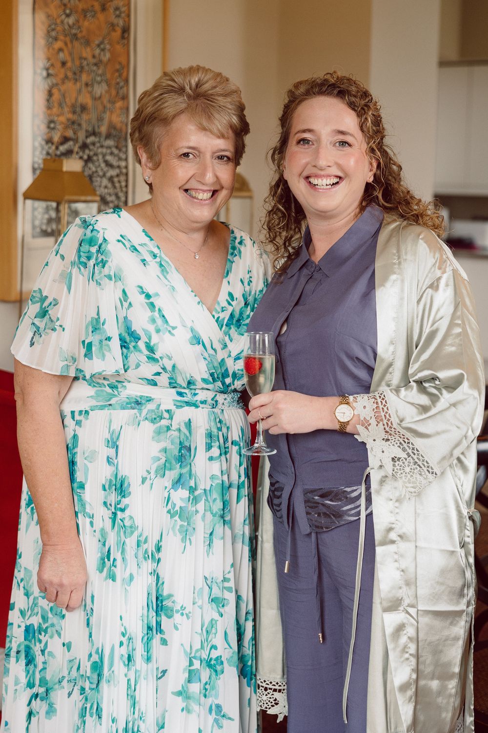A series of candid photos showing two people in contrasting outfits of green floral and navy blue standing together.