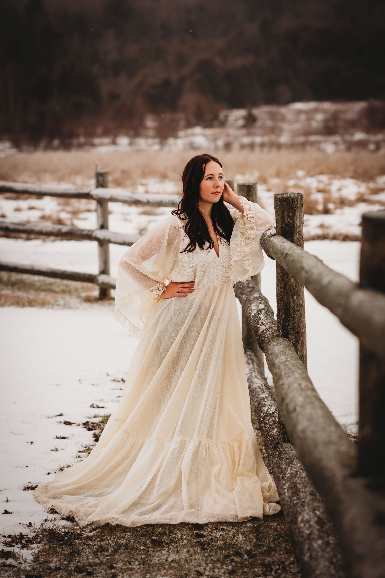 Model wearing a cream-coloured dress during a portrait photography session.