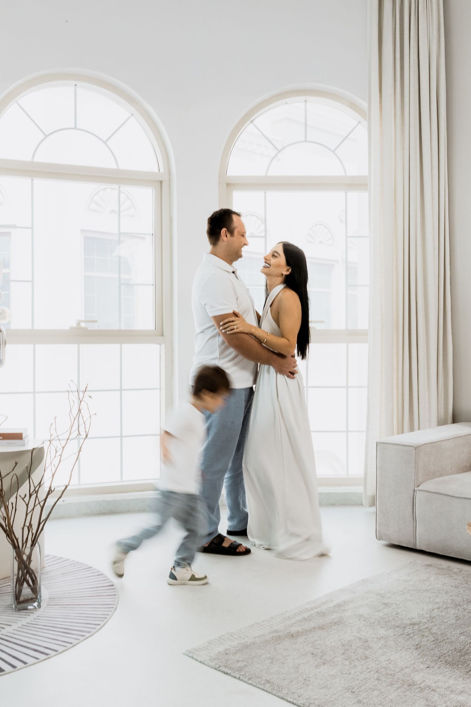 Elegant family photoshoot in bright natural light interior