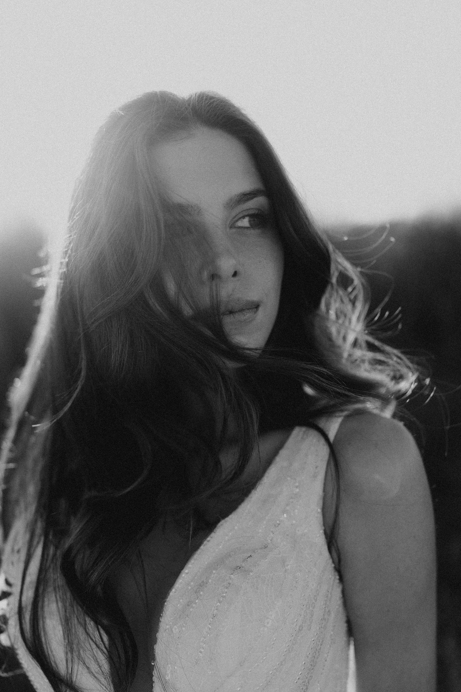 Black and white artistic portraits showing dramatic side lighting and movement.