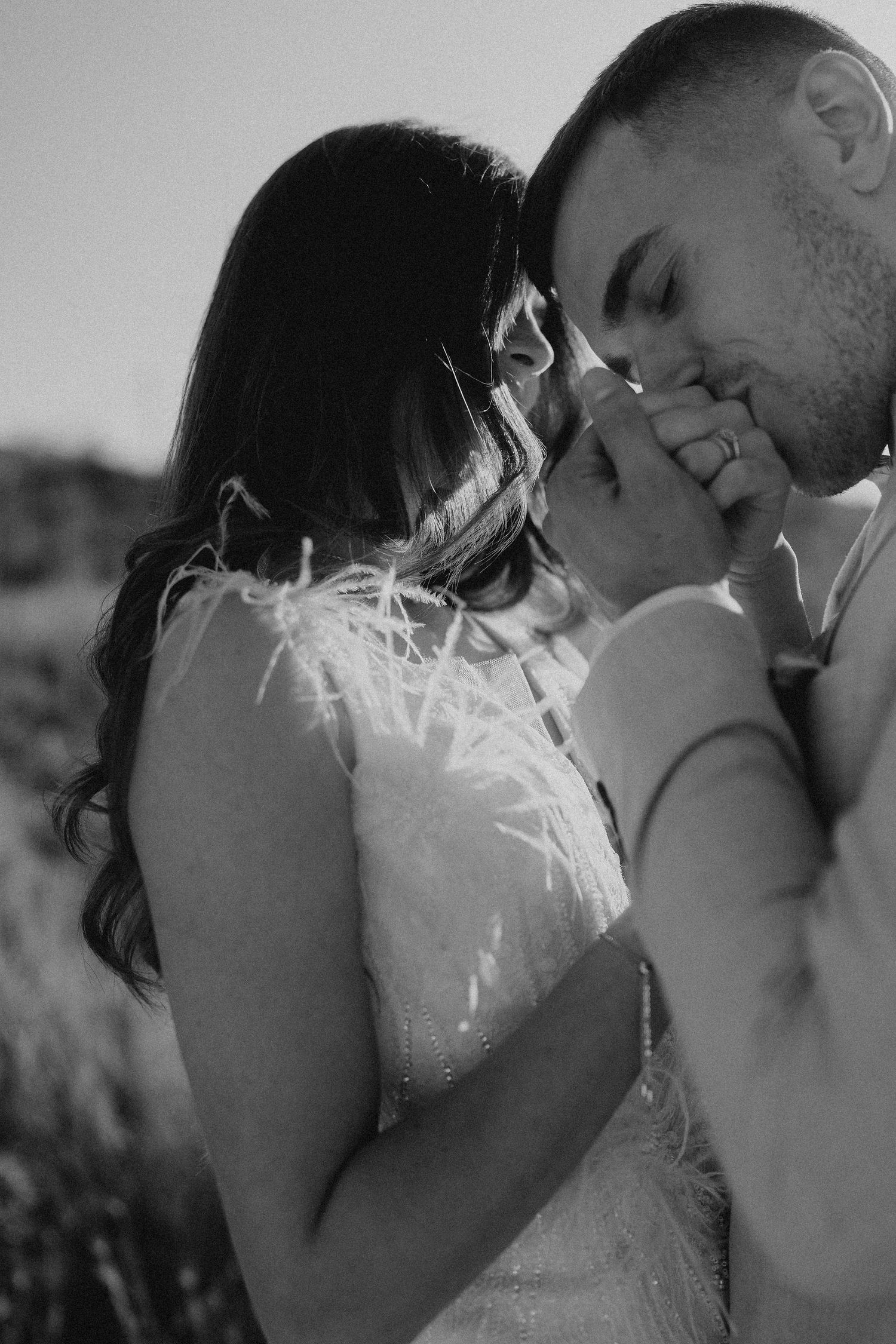 Black and white intimate portrait of couple sharing a tender moment.