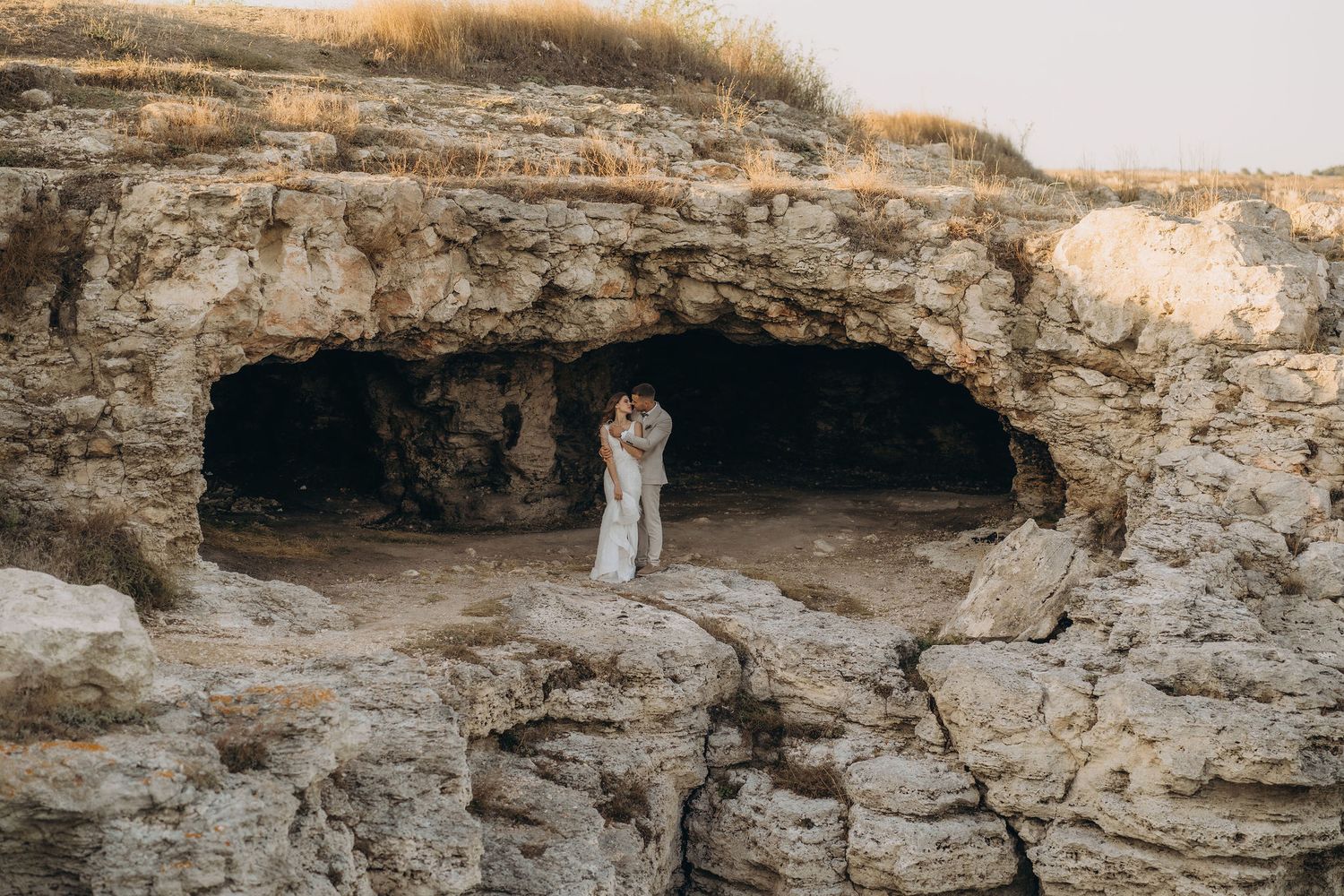 Ancient limestone caves and rock formations create dramatic shadows in golden evening light.