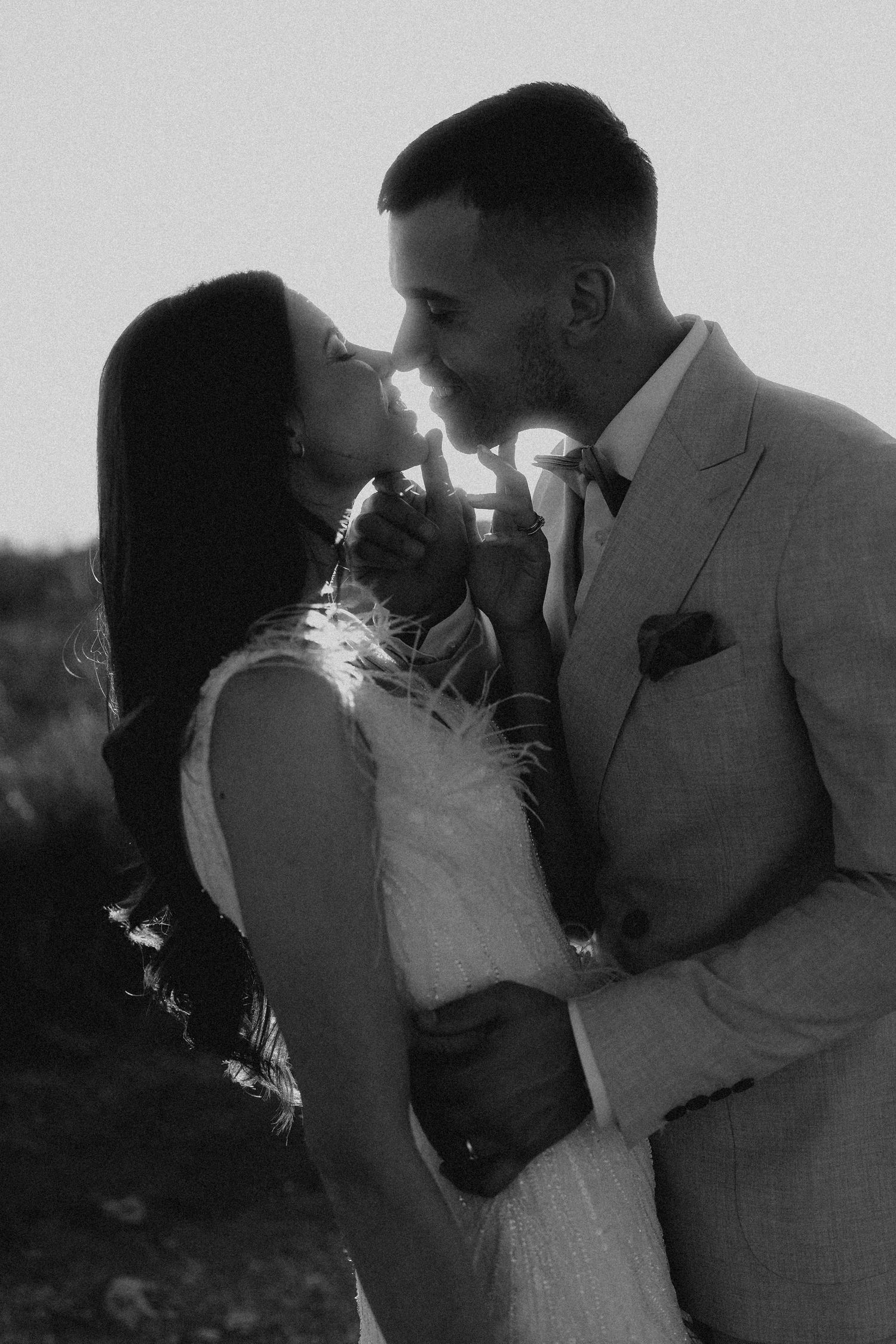 Artistic black and white wedding photos showing tender moments between newlyweds.