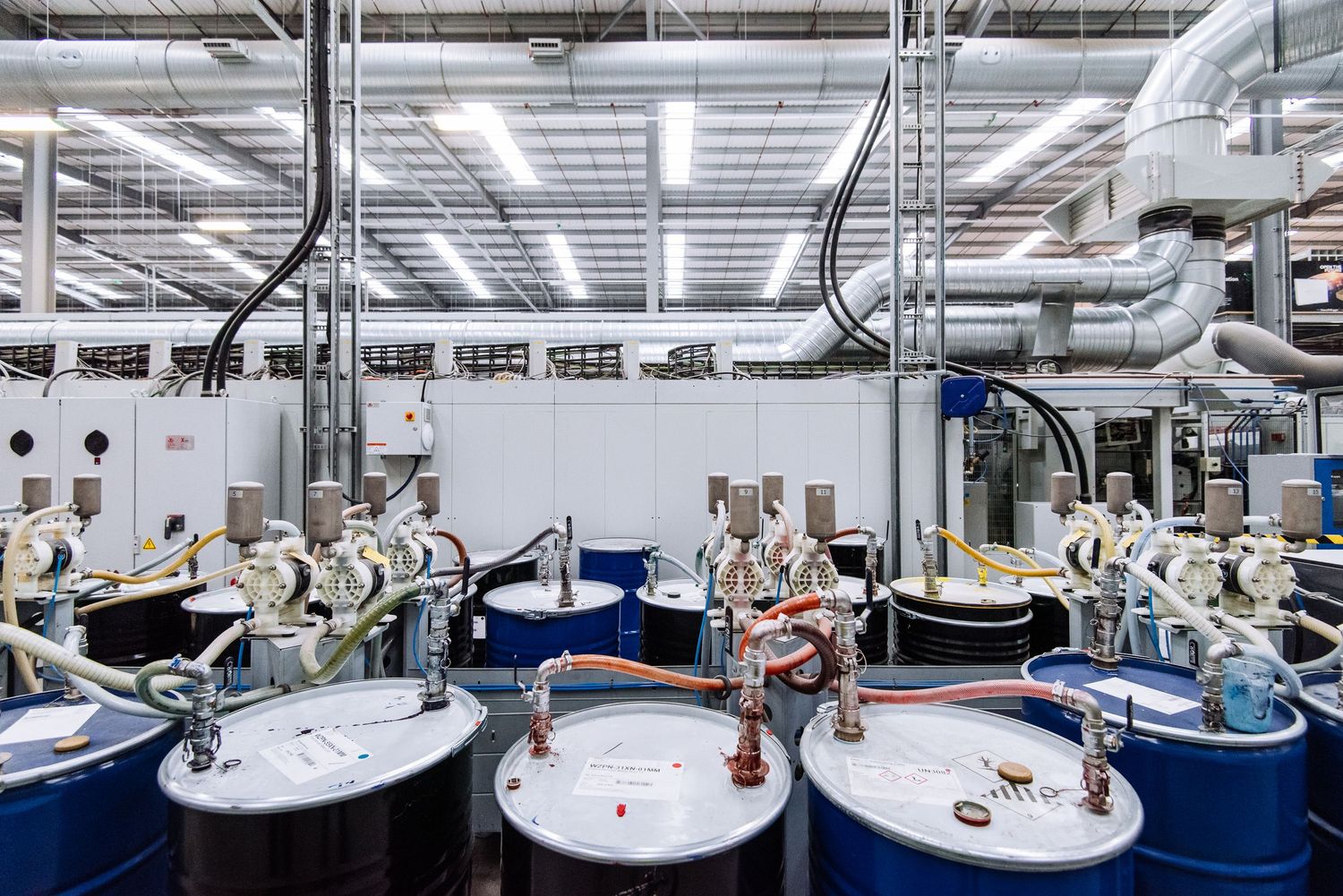 Automated manufacturing facility with robotic equipment and conveyor systems in a clean, well-lit environment.