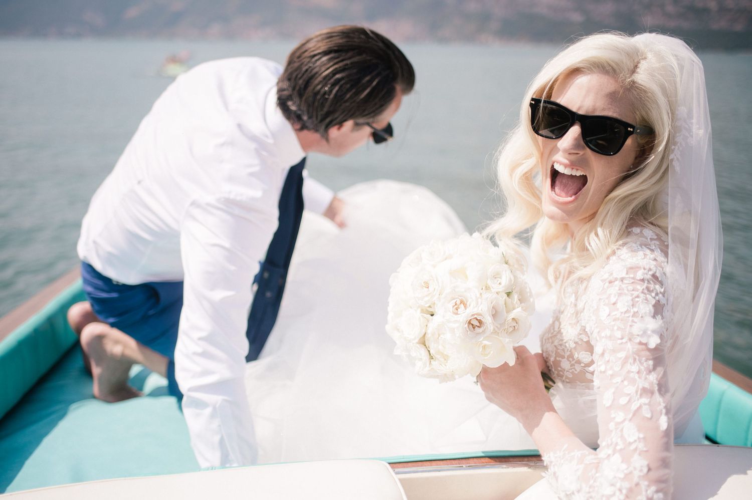 Joyful dutch couple on a Riva boat on their wedding day